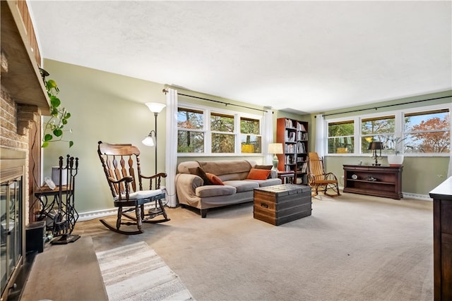 living room with carpet flooring, plenty of natural light, and a brick fireplace