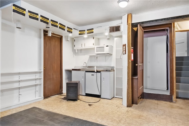 kitchen featuring white cabinetry, sink, and white appliances