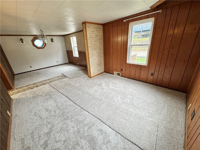 interior space featuring wood walls and light carpet