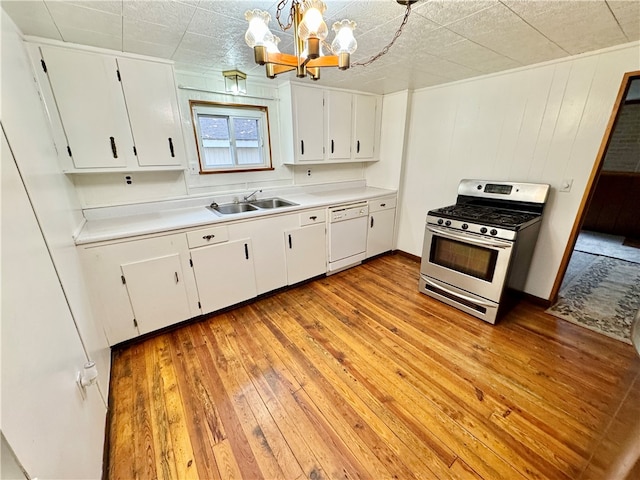 kitchen with white cabinetry, light hardwood / wood-style flooring, white dishwasher, pendant lighting, and stainless steel range with gas stovetop