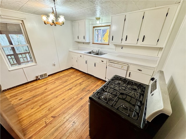 kitchen featuring black range oven, hanging light fixtures, light hardwood / wood-style flooring, white dishwasher, and white cabinets