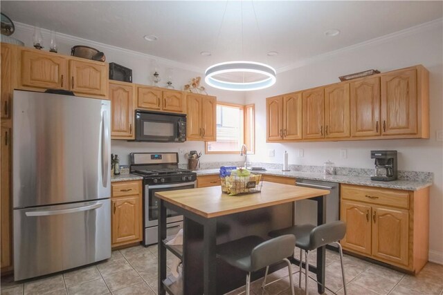 kitchen featuring crown molding, sink, light tile patterned floors, appliances with stainless steel finishes, and light stone counters