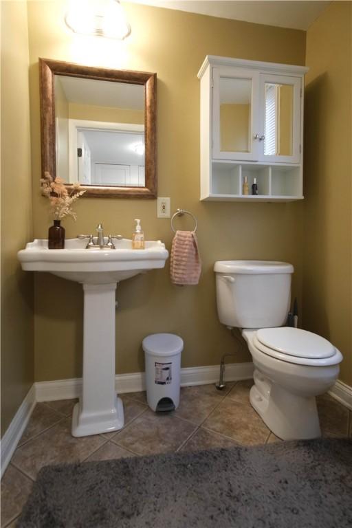 bathroom with tile patterned flooring and toilet