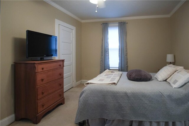 carpeted bedroom featuring ceiling fan and ornamental molding