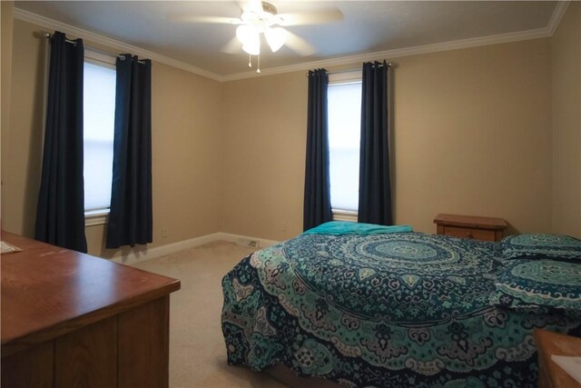 carpeted bedroom featuring ceiling fan and crown molding