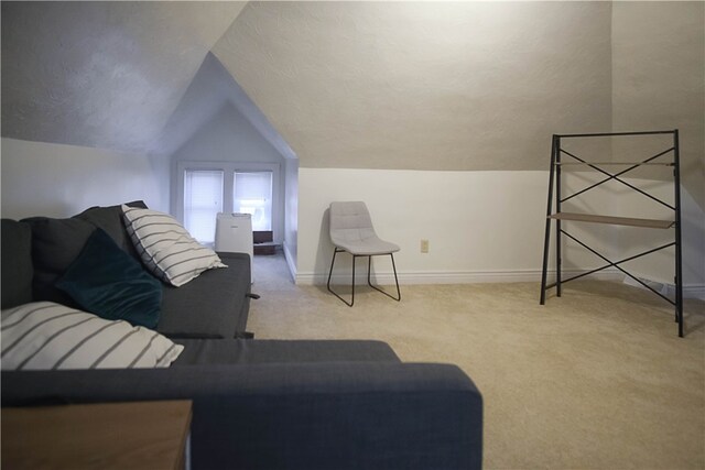 living room featuring light colored carpet and vaulted ceiling