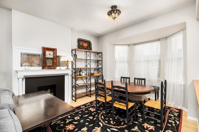 dining space with plenty of natural light and light hardwood / wood-style flooring