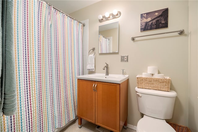 bathroom featuring vanity, toilet, and curtained shower