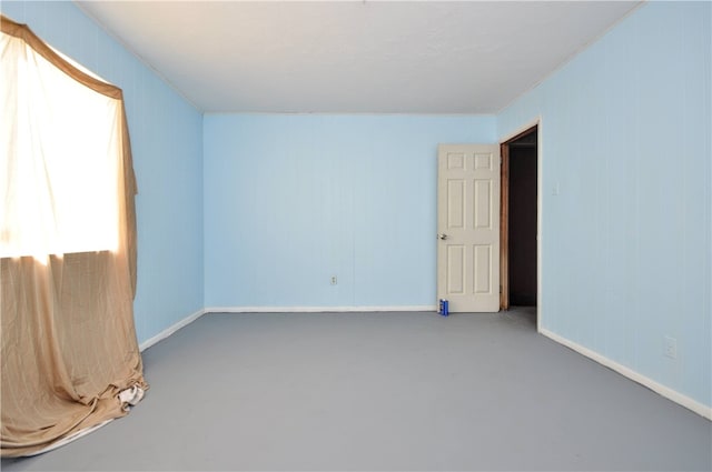 unfurnished room featuring concrete flooring