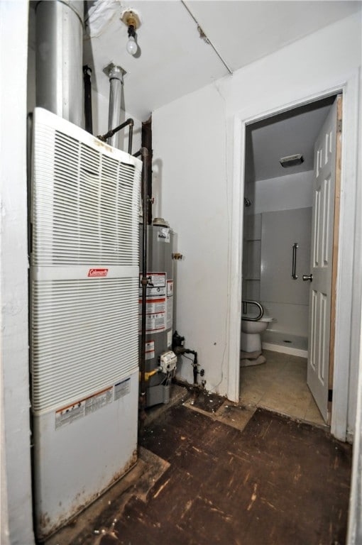 utility room featuring gas water heater and heating unit