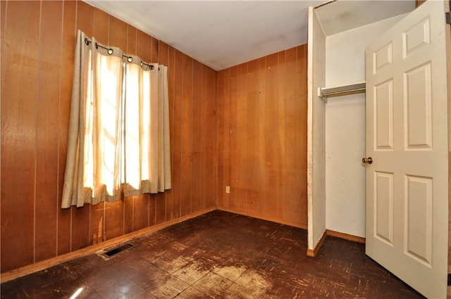 unfurnished bedroom with wooden walls