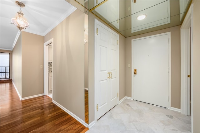 foyer featuring light hardwood / wood-style flooring and crown molding