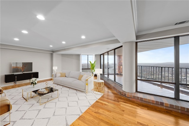 living room with crown molding, hardwood / wood-style floors, and a water view