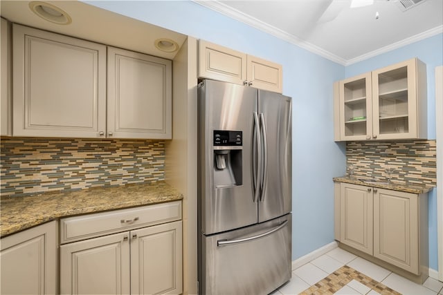 kitchen with tasteful backsplash, stainless steel fridge, light tile patterned floors, and ornamental molding