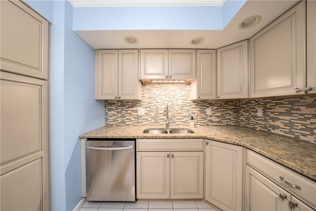 kitchen with backsplash, sink, stainless steel dishwasher, light tile patterned flooring, and light stone counters