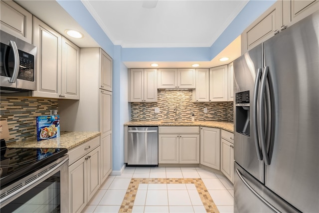 kitchen with backsplash, stainless steel appliances, crown molding, sink, and light tile patterned flooring