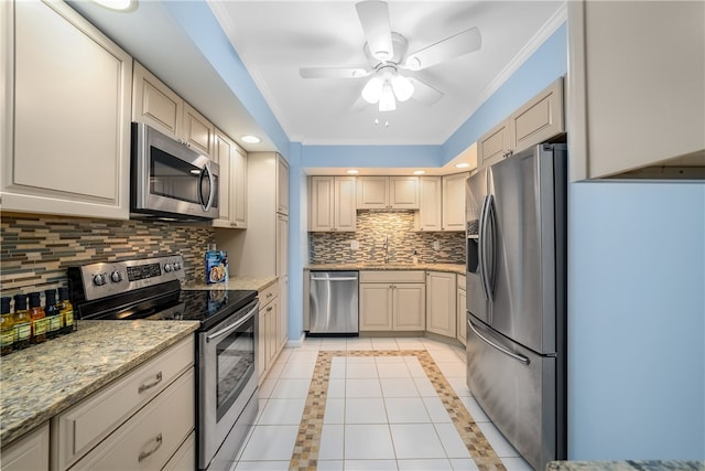 kitchen featuring tasteful backsplash, stainless steel appliances, ceiling fan, crown molding, and light tile patterned floors