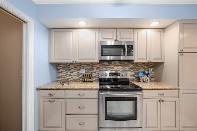 kitchen featuring tasteful backsplash, white cabinetry, and appliances with stainless steel finishes