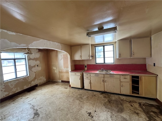 kitchen with cream cabinetry and sink