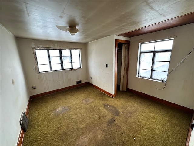 unfurnished room featuring carpet flooring and a wealth of natural light