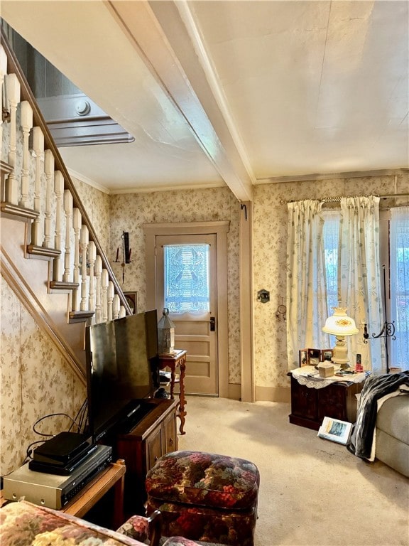 miscellaneous room with carpet, beam ceiling, and ornamental molding