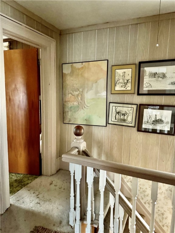 corridor featuring wooden walls and concrete floors