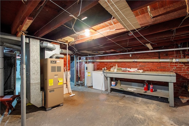 basement with brick wall, washer / dryer, heating unit, and water heater