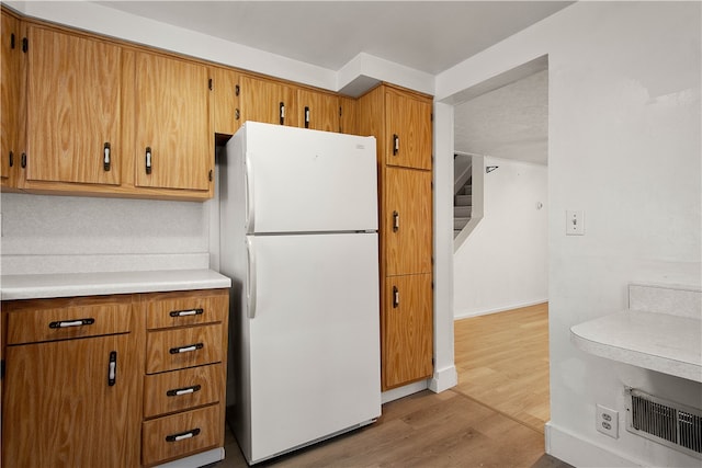 kitchen with white fridge and light wood-type flooring