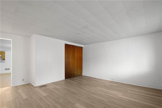 unfurnished room featuring light hardwood / wood-style flooring