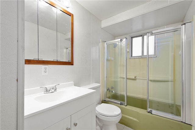 full bathroom featuring vanity, toilet, tile walls, and bath / shower combo with glass door