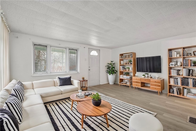 living room featuring hardwood / wood-style floors and a textured ceiling