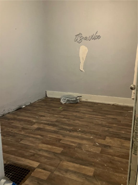 empty room featuring dark wood-type flooring