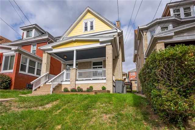 view of front facade with a porch and a front yard