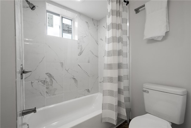 bathroom featuring shower / bath combination with curtain and toilet