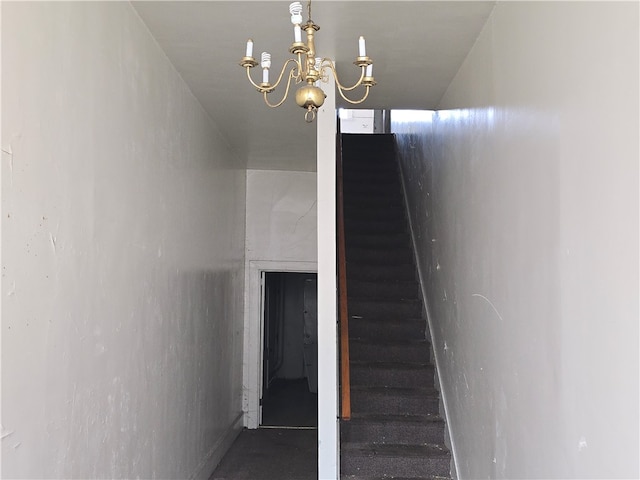 stairway with a chandelier