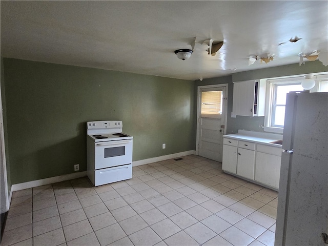 kitchen featuring white cabinets, white appliances, and light tile patterned flooring