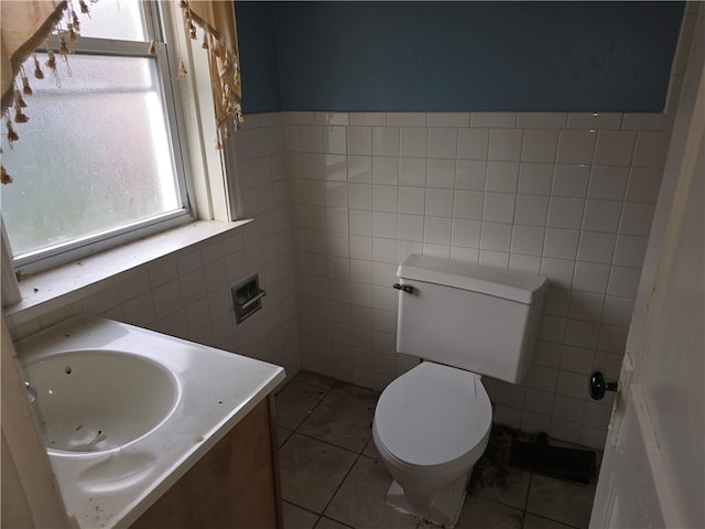 bathroom featuring tile patterned floors, vanity, and tile walls