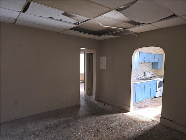 unfurnished room featuring a drop ceiling