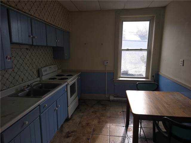 kitchen featuring blue cabinetry, a paneled ceiling, a wealth of natural light, and white electric stove