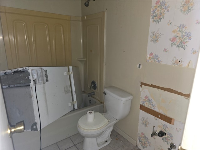 bathroom featuring tile patterned floors, toilet, and shower / washtub combination