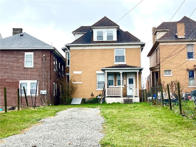 view of front of property with a front yard and covered porch