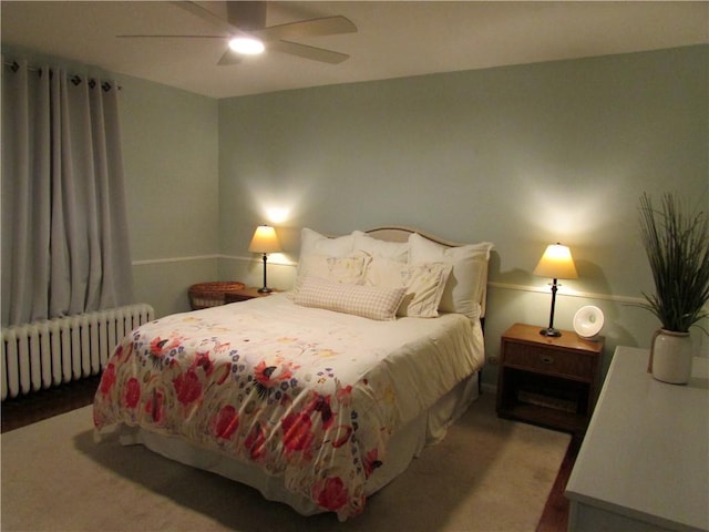 carpeted bedroom with radiator and ceiling fan