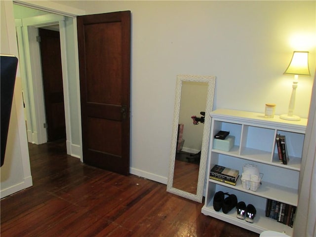 hallway with dark hardwood / wood-style floors