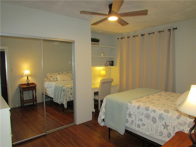 bedroom with ceiling fan, dark hardwood / wood-style floors, and a closet