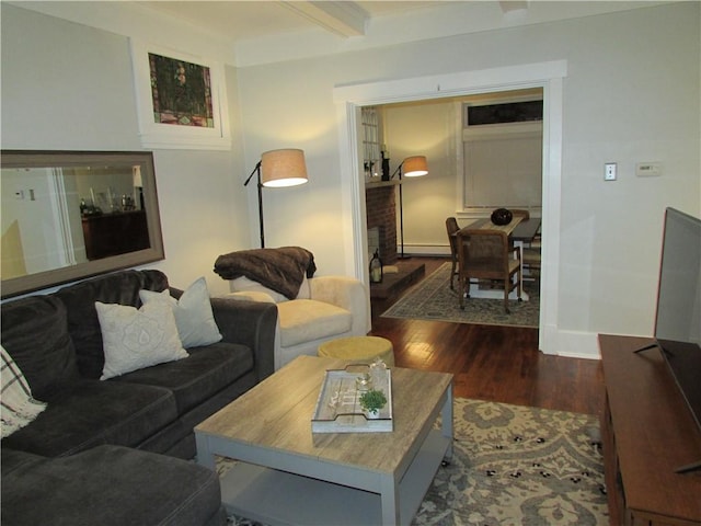 living room featuring beamed ceiling, a baseboard radiator, and dark hardwood / wood-style floors