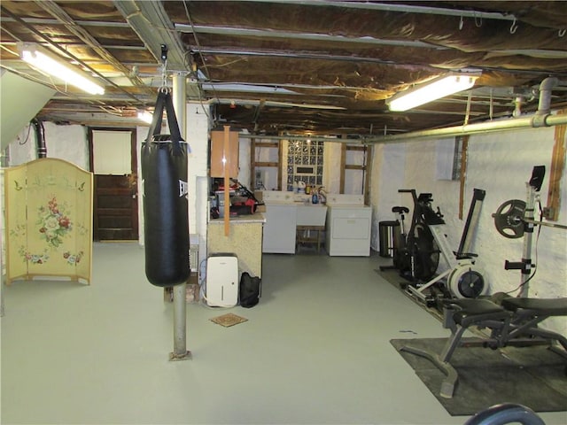 basement featuring washer and dryer and sink