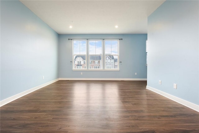 unfurnished room with dark hardwood / wood-style floors