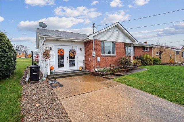 exterior space with a front lawn and french doors