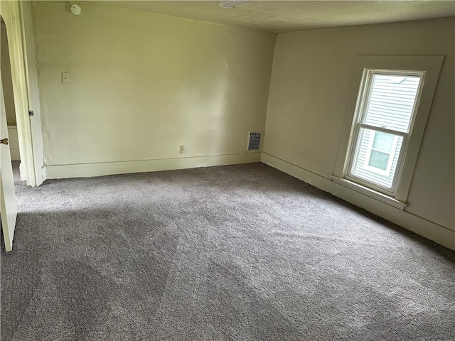 unfurnished room featuring carpet flooring and a textured ceiling