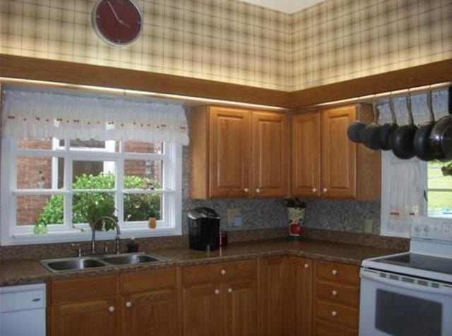 kitchen featuring white appliances and sink